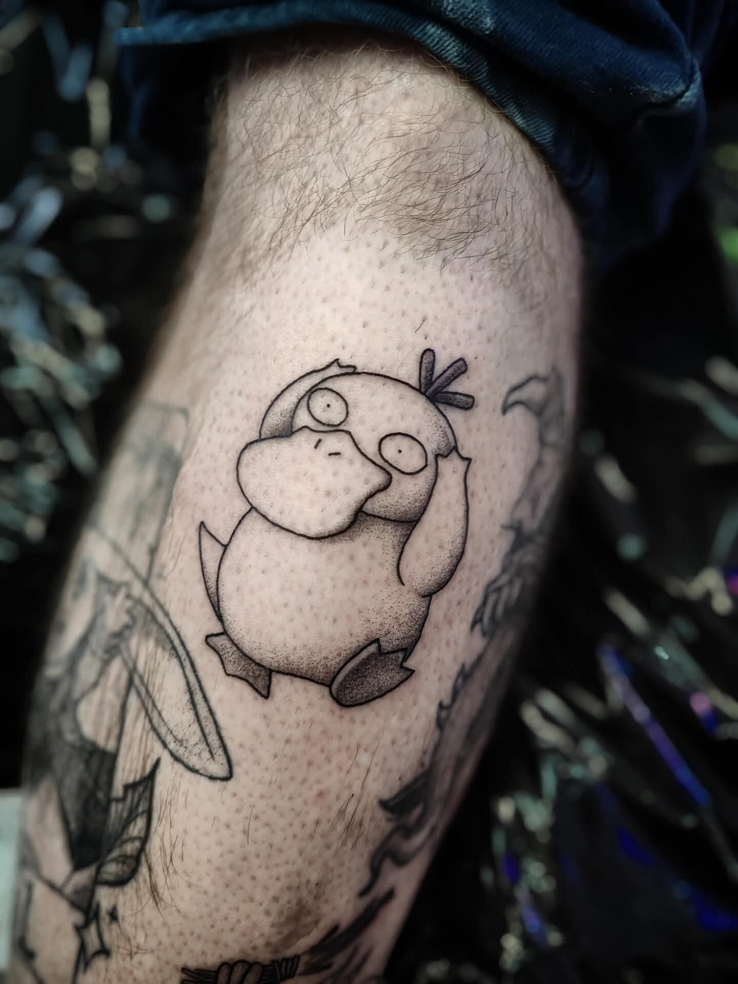 Cartoony tattoo of pokemon psyduck