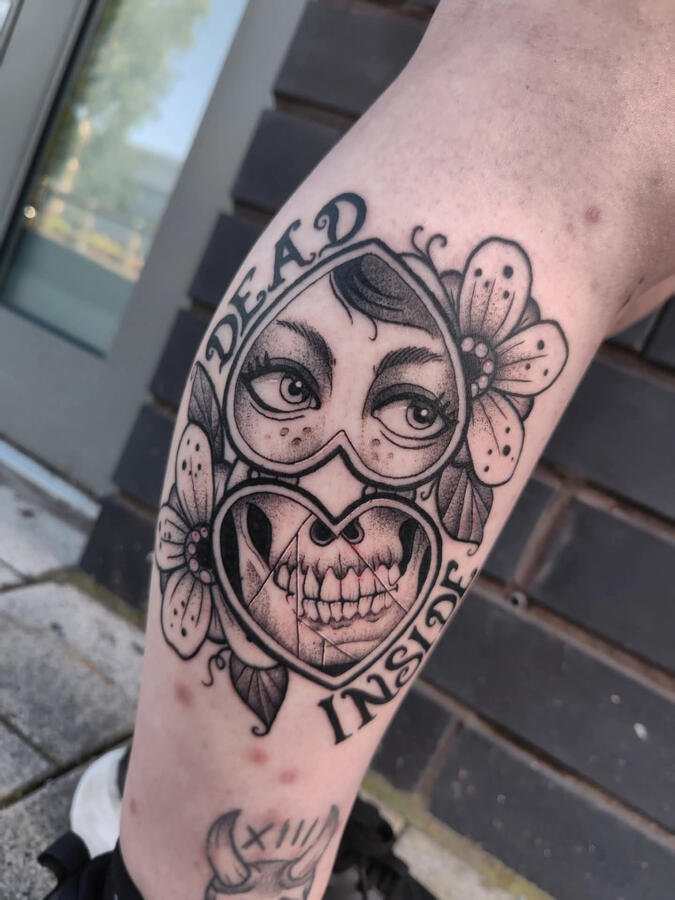 Blackwork gothic tattoo of a heart shaped mirror and flowers