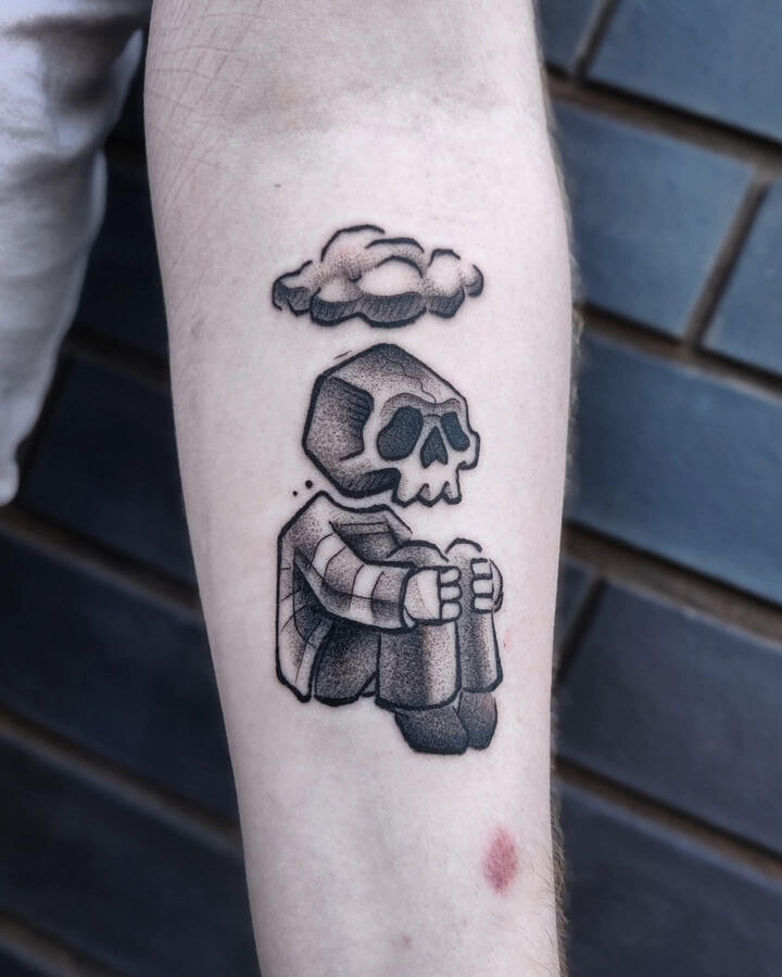 Cartoon style tattoo showing a sad skeleton with a dark cloud above his head