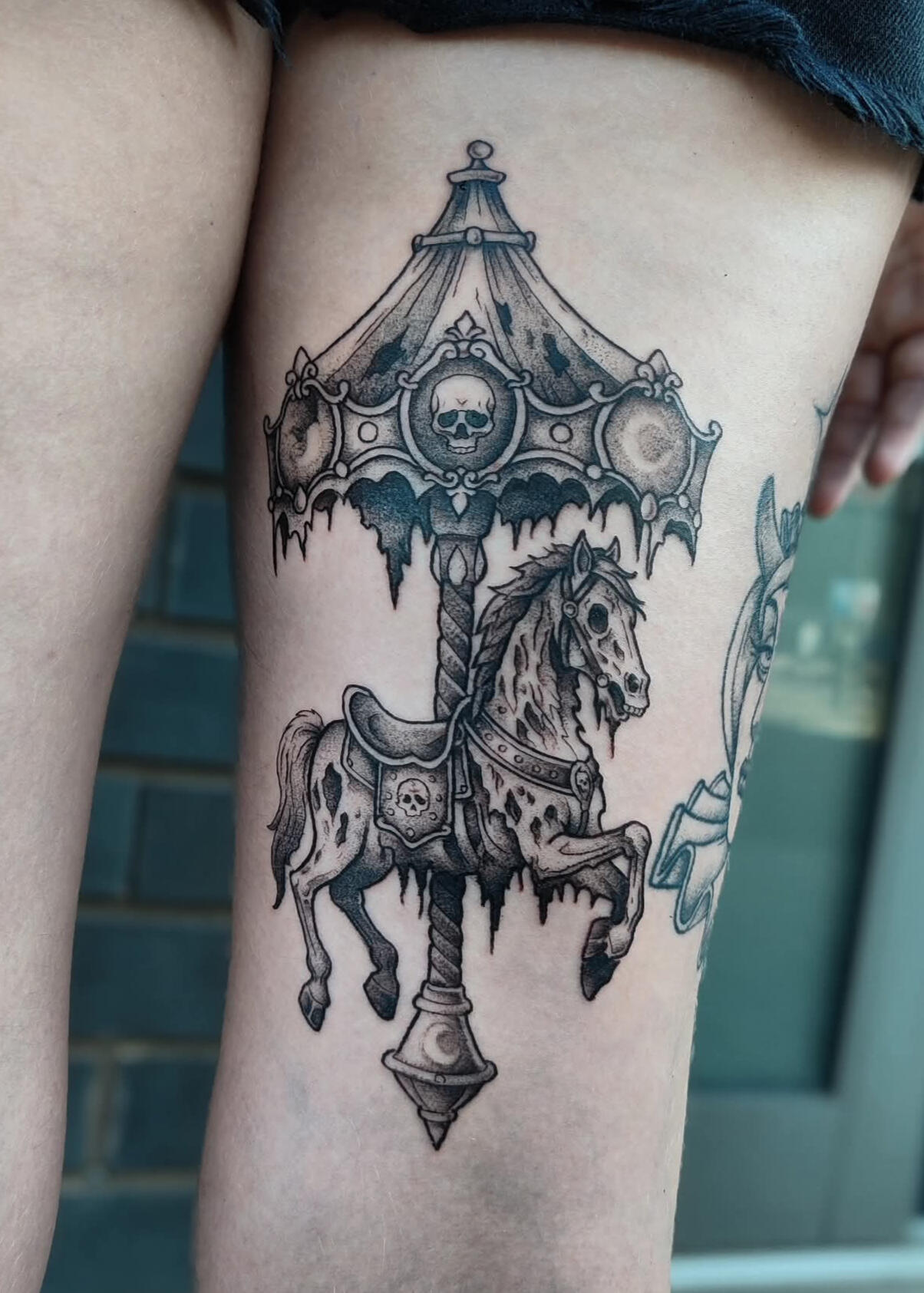 Blackwork gothic tattoo of a decying creepy carousel