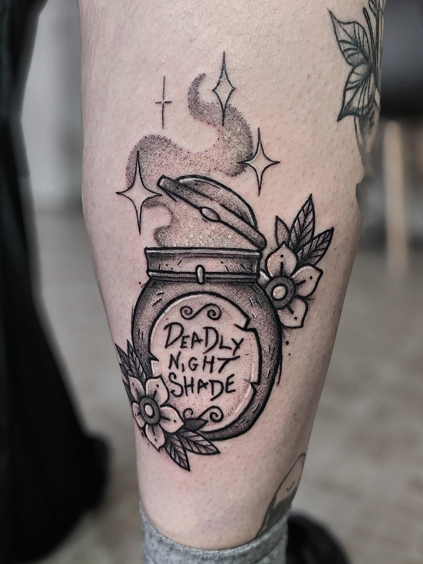 Blackwork tattoo of the deadly night shade jar from nighttime before christmas