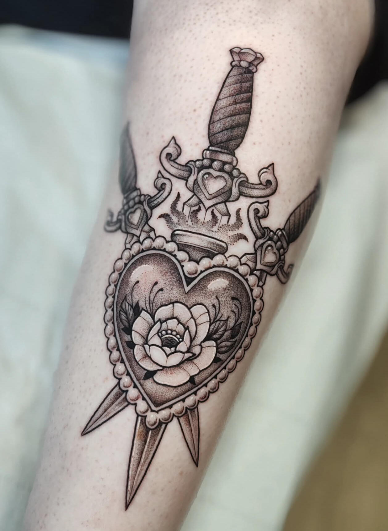 Blackwork sacred heart with flower and daggers